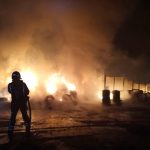 Firefighters control fire at a wood processing and waste management factory